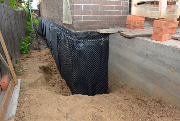 SJ Waterproofing Pros technician performing targeted Wet Basement Repair assessment in Milwaukee, WI